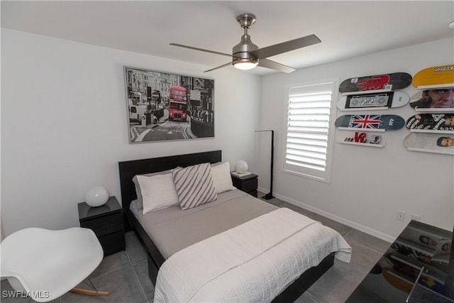 bedroom with a ceiling fan and baseboards