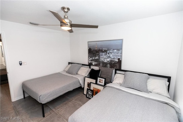 bedroom with ceiling fan, visible vents, and tile patterned floors