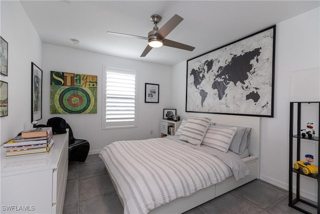 bedroom with ceiling fan and dark tile patterned flooring