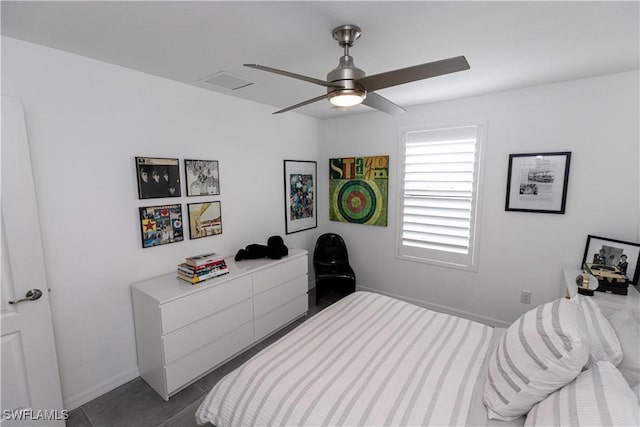 tiled bedroom with baseboards, visible vents, and a ceiling fan