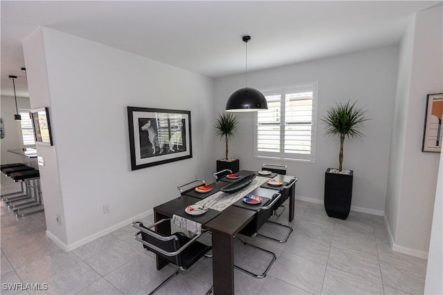 dining area featuring baseboards and light tile patterned floors