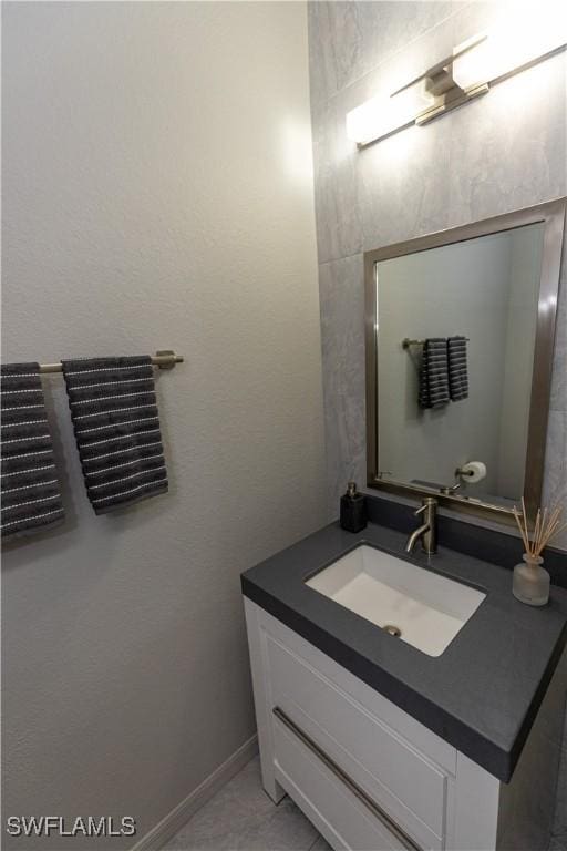 bathroom featuring baseboards and vanity