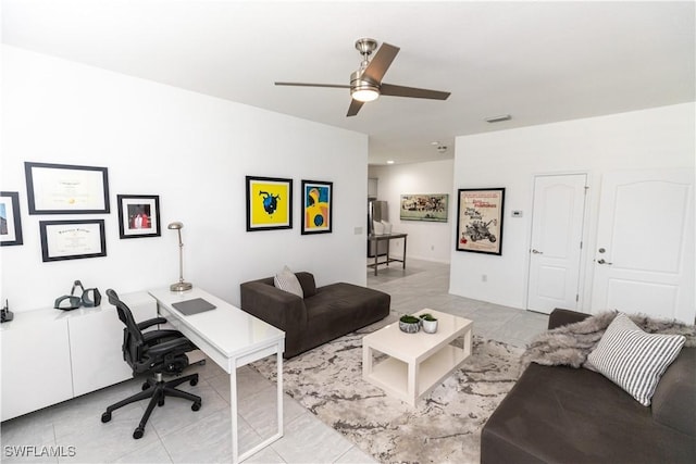 living area featuring ceiling fan and visible vents