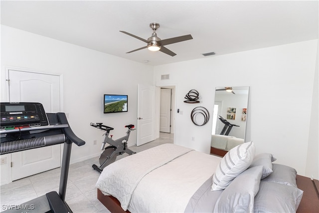 bedroom featuring light tile patterned flooring, visible vents, and a ceiling fan