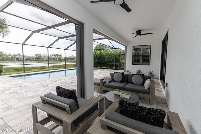 exterior space with a water view, glass enclosure, outdoor lounge area, ceiling fan, and a patio