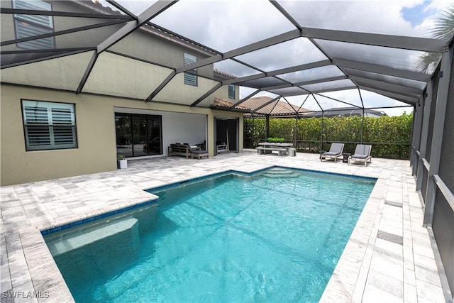 view of swimming pool with an outdoor living space, a lanai, and a patio