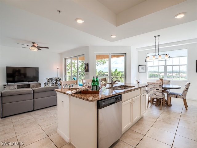 kitchen featuring sink, pendant lighting, stone countertops, an island with sink, and dishwasher