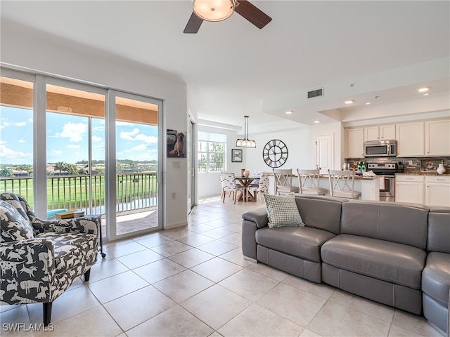 tiled living room featuring ceiling fan