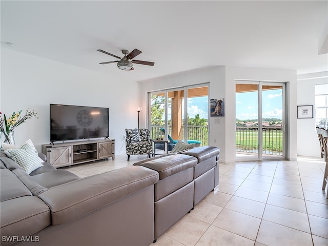 tiled living room featuring ceiling fan and a wealth of natural light