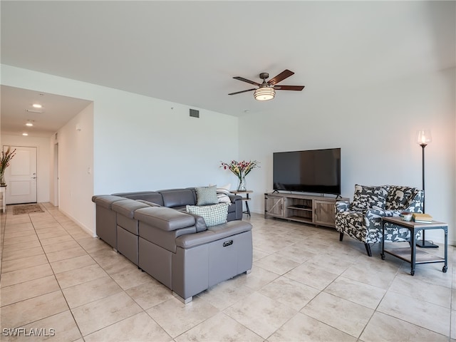 living room featuring light tile patterned floors and ceiling fan