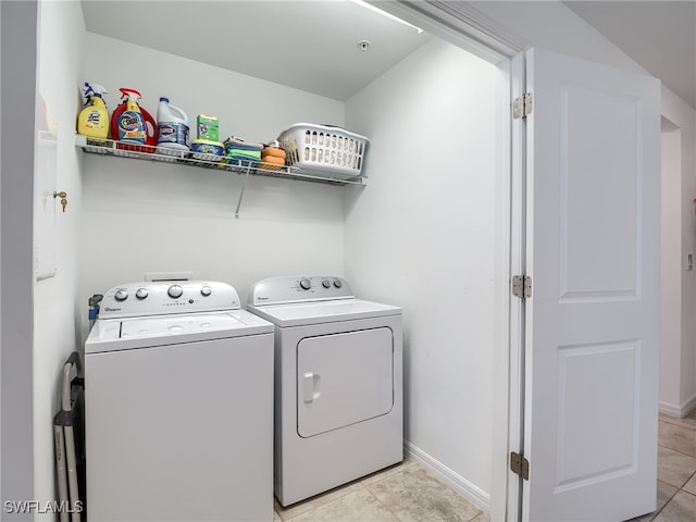 laundry room featuring light tile patterned flooring and washing machine and dryer