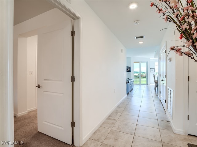 hall with light tile patterned floors