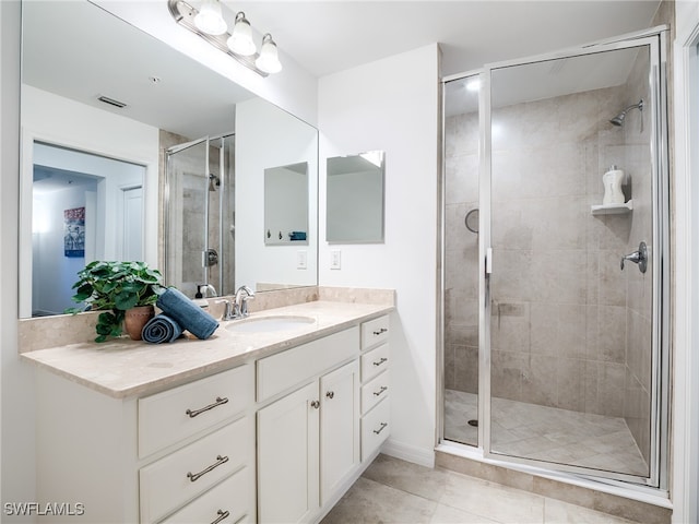 bathroom featuring vanity, walk in shower, and tile patterned floors