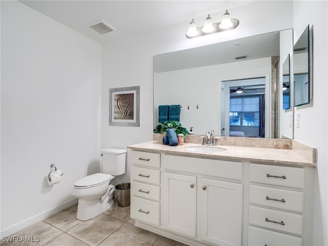 bathroom with tile patterned floors, vanity, and toilet