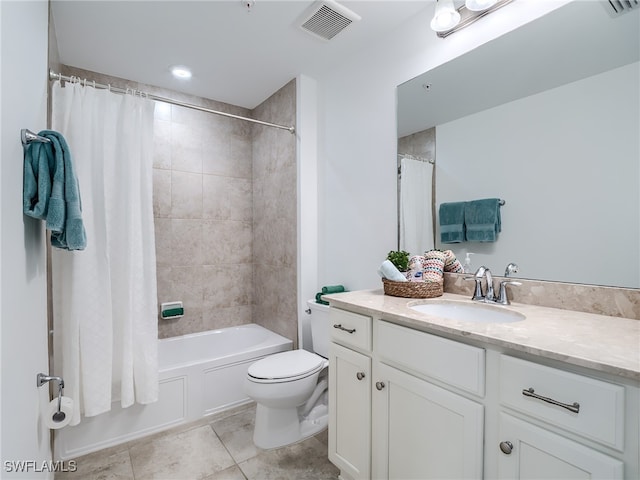 full bathroom featuring vanity, shower / bath combo with shower curtain, tile patterned flooring, and toilet