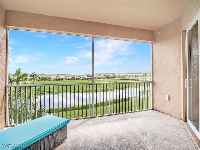 unfurnished sunroom with a water view