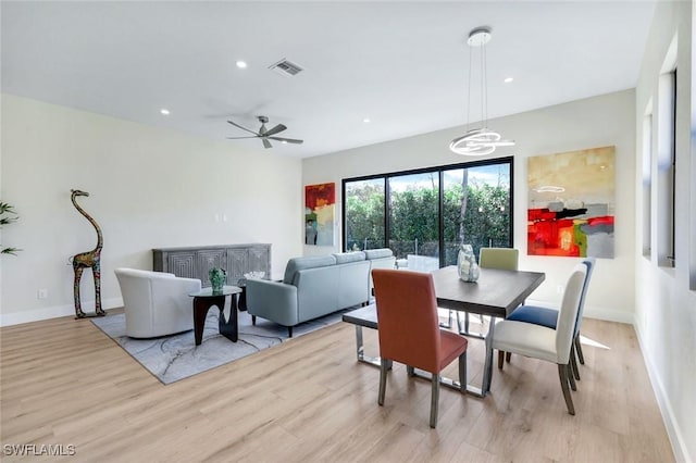 dining room with recessed lighting, baseboards, visible vents, and light wood-type flooring