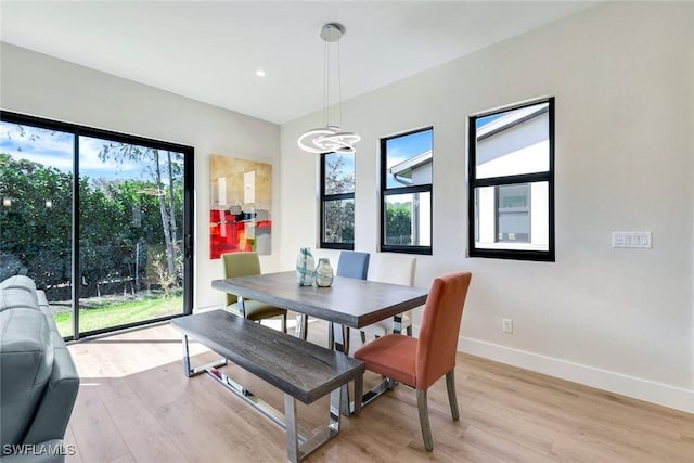 dining space with light wood finished floors, recessed lighting, and baseboards