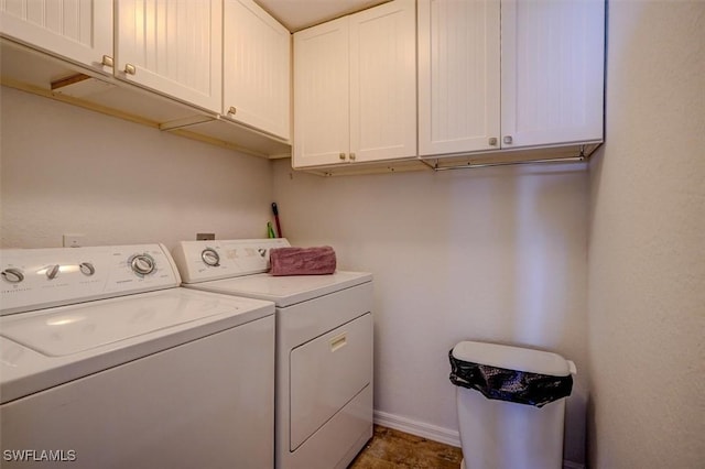 laundry room featuring cabinets and separate washer and dryer