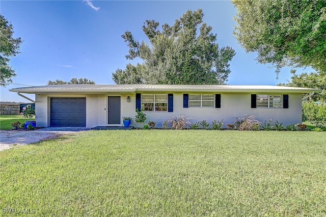 single story home with a front lawn and a garage