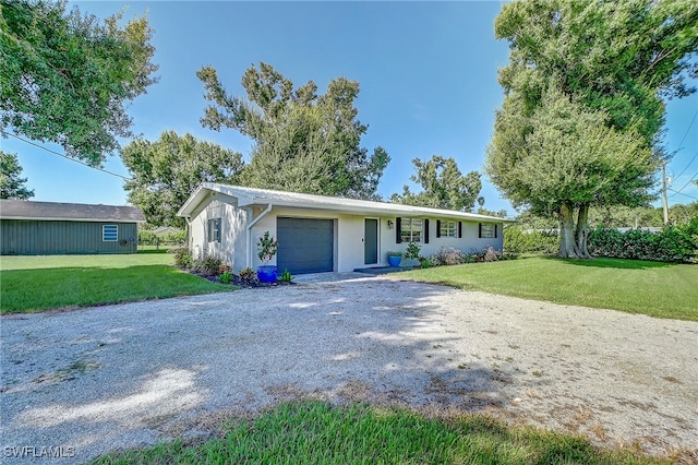 single story home featuring a garage and a front yard