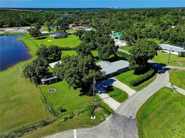 birds eye view of property featuring a water view and a view of trees