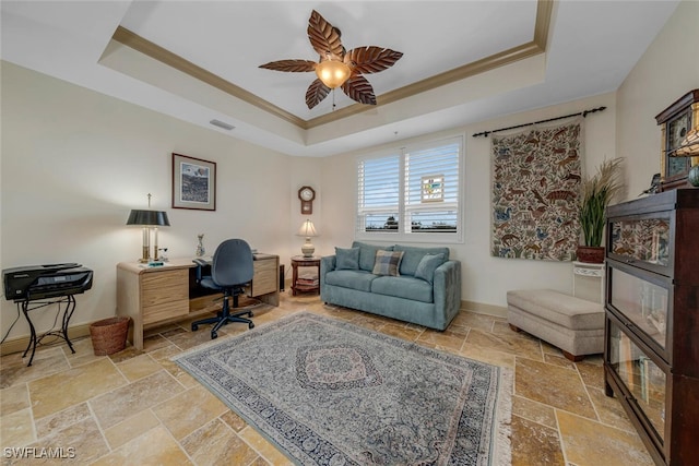 office space featuring ceiling fan, ornamental molding, and a tray ceiling