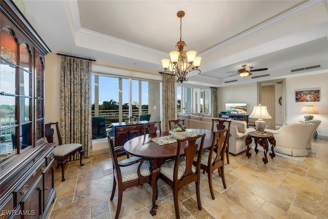 dining area with a raised ceiling, crown molding, and ceiling fan with notable chandelier