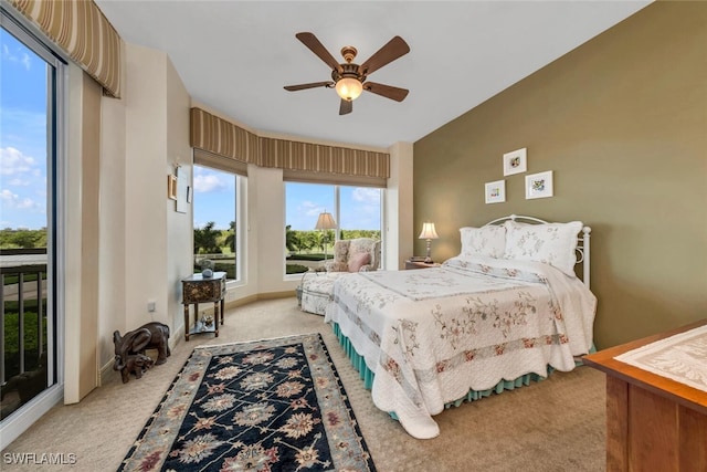 bedroom with access to outside, light colored carpet, and ceiling fan