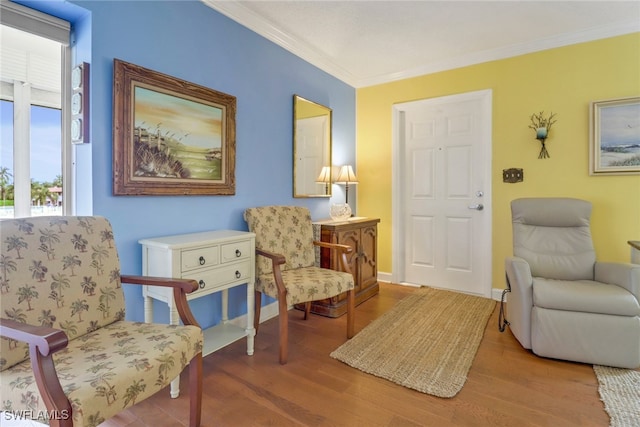 living area featuring crown molding and wood-type flooring