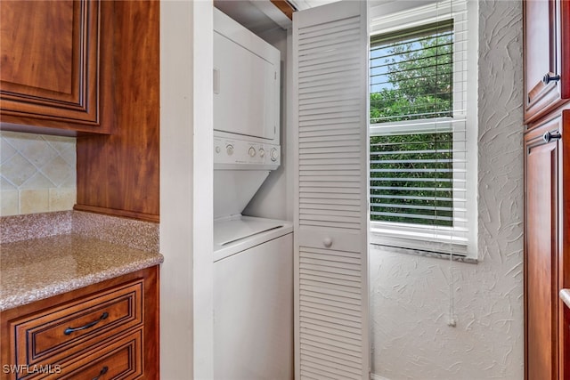 laundry room featuring stacked washer and dryer