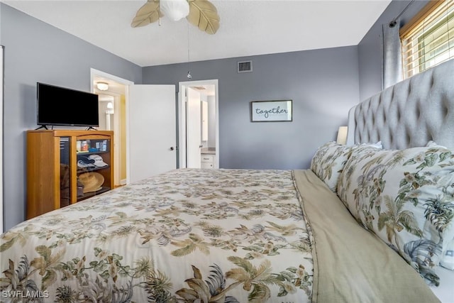 bedroom with ceiling fan and ensuite bathroom