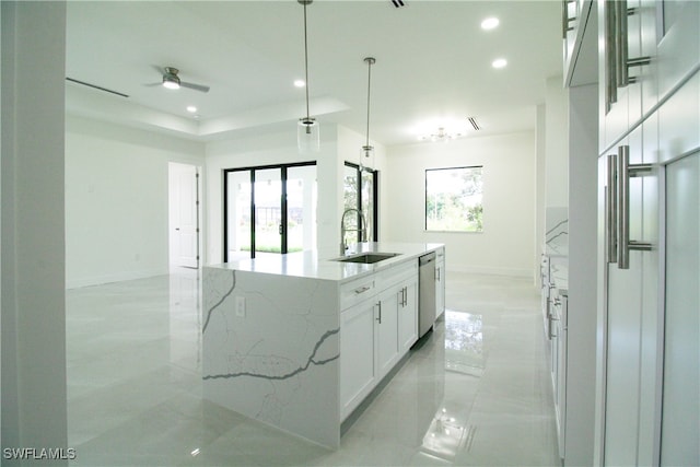 kitchen featuring a center island with sink, a wealth of natural light, sink, and white cabinets