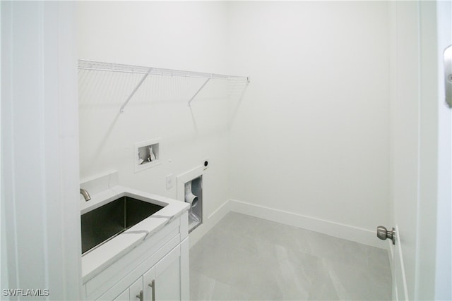 laundry room with cabinets, hookup for an electric dryer, hookup for a washing machine, and sink