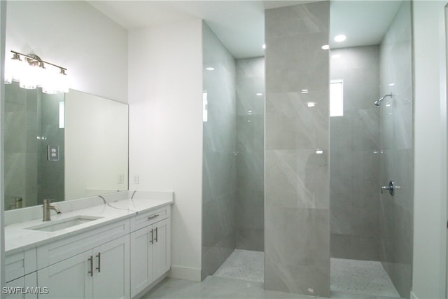 bathroom featuring tiled shower and vanity