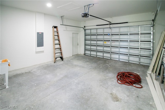 garage with a garage door opener and electric panel