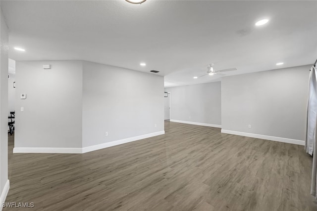 basement with ceiling fan and hardwood / wood-style flooring