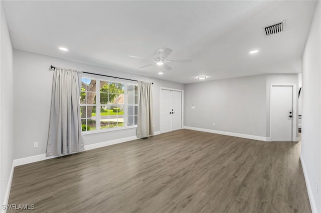 unfurnished room featuring ceiling fan and dark hardwood / wood-style floors