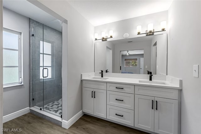 bathroom featuring ceiling fan, hardwood / wood-style floors, vanity, and an enclosed shower