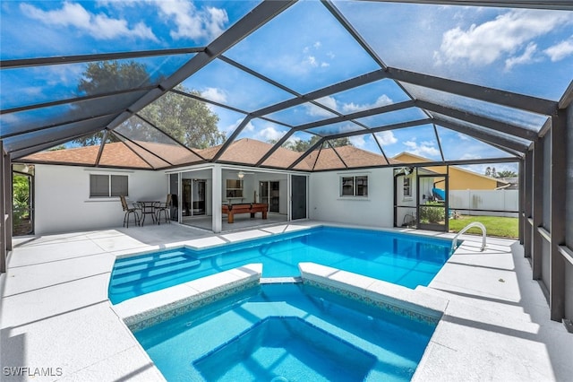 view of swimming pool featuring a lanai, a patio area, and an in ground hot tub