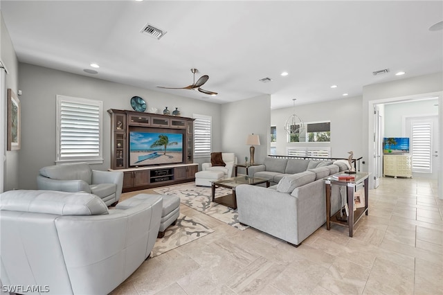 tiled living room with a healthy amount of sunlight and ceiling fan