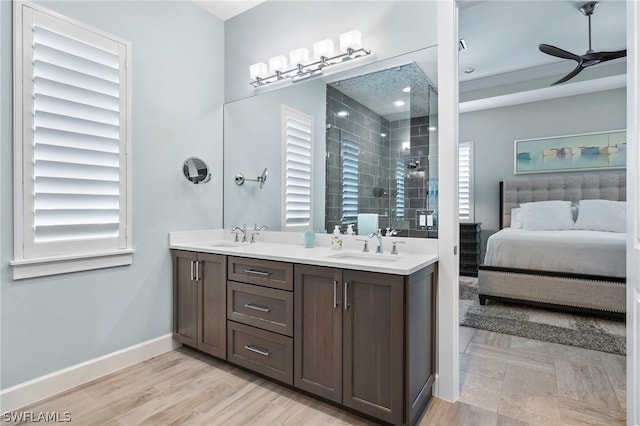 bathroom featuring double vanity, wood-type flooring, a wealth of natural light, and ceiling fan