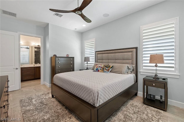 bedroom with connected bathroom, light tile patterned floors, and ceiling fan