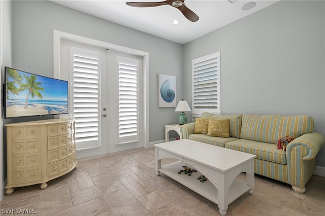 tiled living room with french doors and ceiling fan