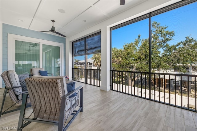 sunroom featuring ceiling fan