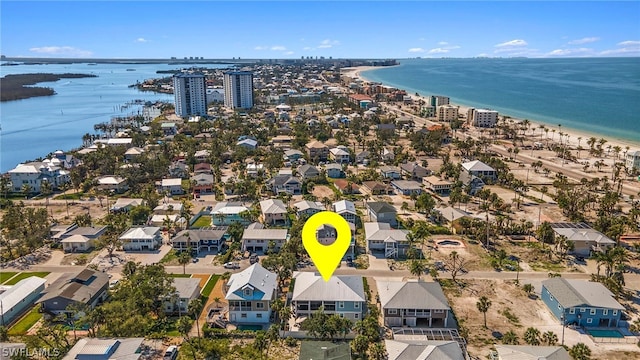 aerial view with a water view and a beach view