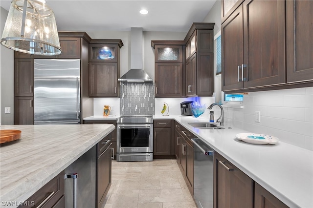 kitchen featuring tasteful backsplash, appliances with stainless steel finishes, sink, and wall chimney range hood