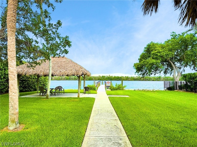 surrounding community featuring a gazebo, a water view, and a lawn