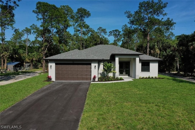 view of front of house with stucco siding, a front yard, and driveway