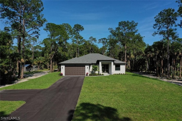 view of front of property with a garage, stucco siding, a front yard, and aphalt driveway